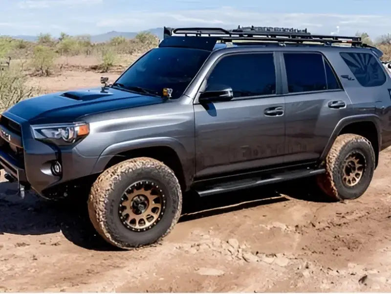 Off-road SUV equipped with 2004-0378BT Raptor 5' Slide Track Ovals Kit, designed for RV, automotive, powersports, and marine uses, ideal for exterior and interior applications, truck bed, rv parts, truck accessories, Nerf Bars & Running Boards, AVADA - Best Sellers, Must Haves.