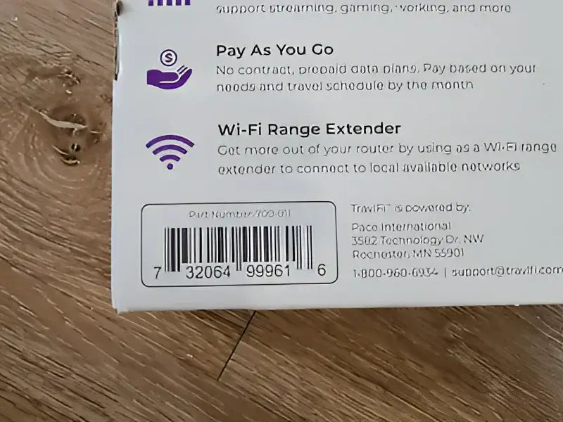 Close-up image of the 700-011 Pace Int'L Travlfi Journey Xtr Router packaging showing the barcode and part number on a wooden surface.