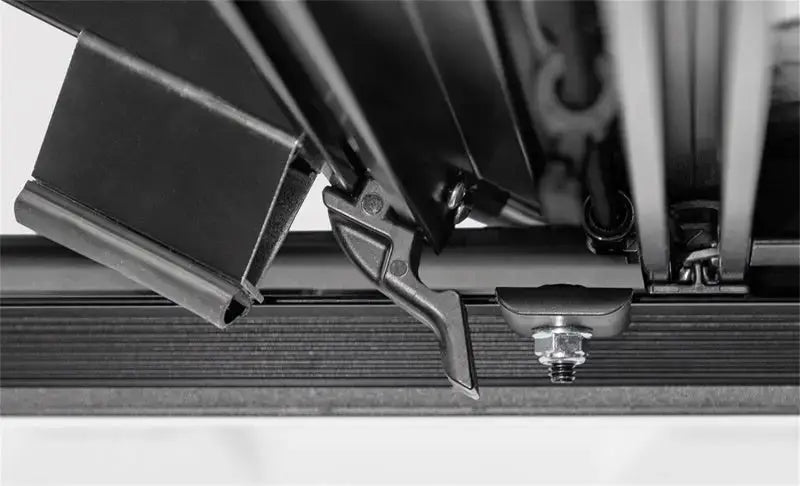 Black metal quick-release clamp mechanism with bolt and nut for Access LOMAX tri-fold cover