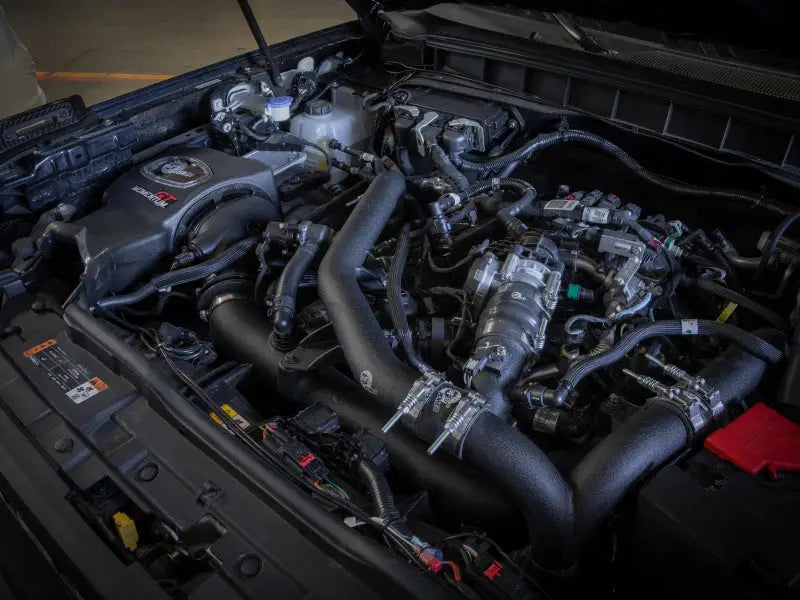 aFe Momentum GT Pro 5R Cold Air Intake System installed in 2021 Ford Bronco V6 2.7 (TT) engine bay. High-performance RV, automotive, powersports, off-road, marine, and truck accessories part, featuring heat-resistant XLPE material. Maximum power gains, optimal airflow.