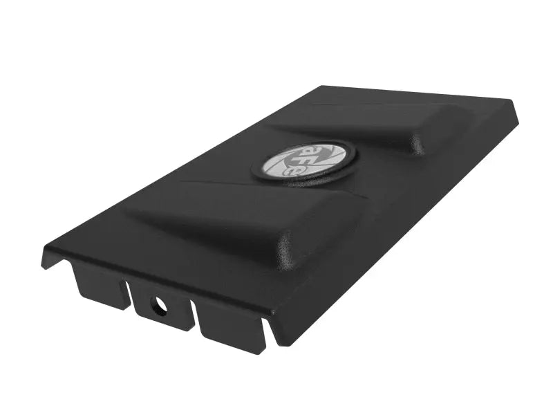 Black aFe Rapid Induction Intake System Cover with raised sections and circular emblem