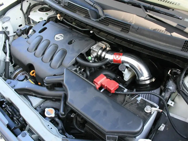 Car engine with aftermarket intake featuring afe takeda intakes on a Nissan Cube 09-12