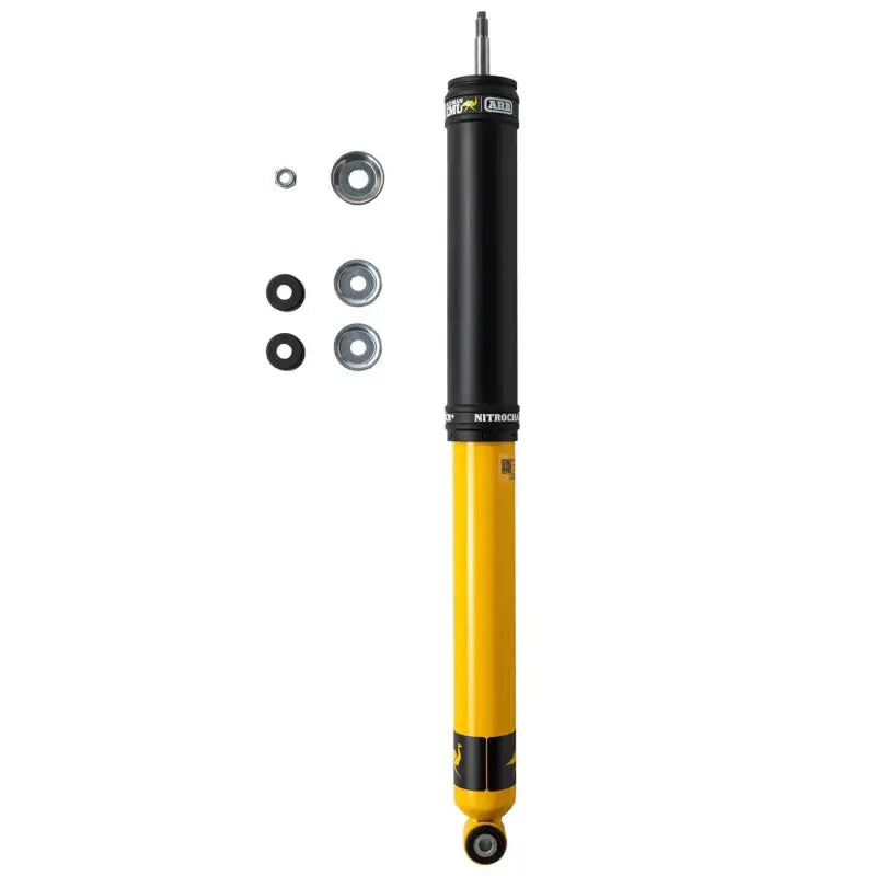 Yellow and black ARB Nitrocharger Plus shock absorber with mounting hardware for Jeep Wrangler JK