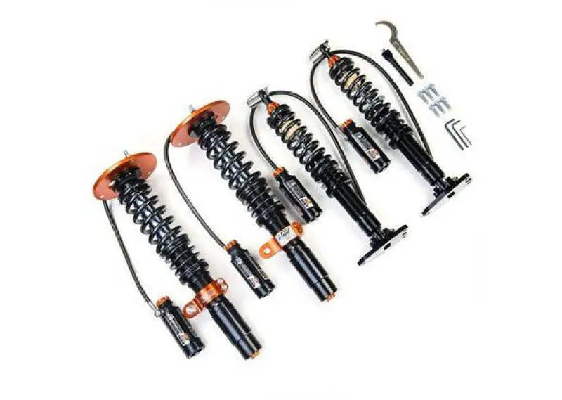 Four black and orange BMW M3 G80 coilovers with reservoirs and tools for better driving experience
