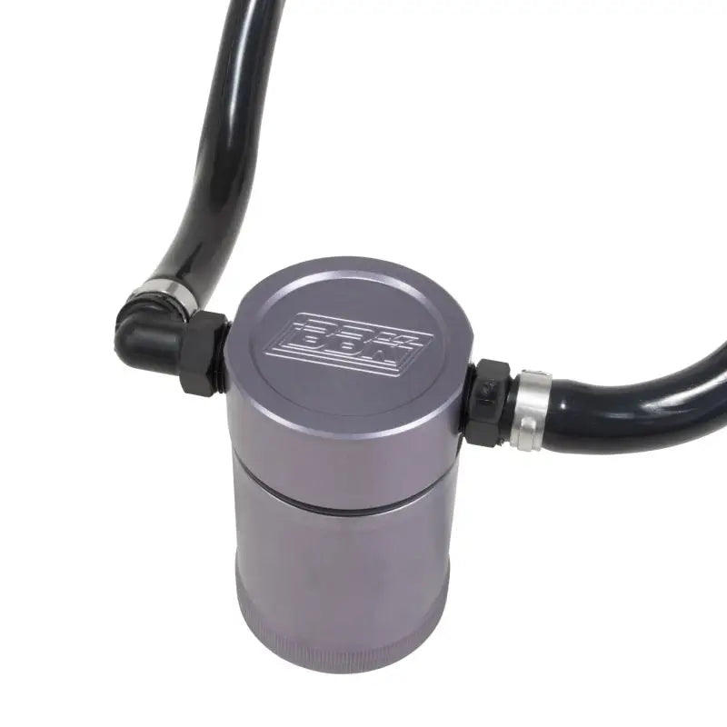 Gray cylindrical oil separator with black hoses from BBK oil separator kit for Mustang GT