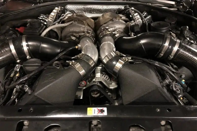 Car engine with twin turbochargers from CSF crinkle black twin charge-air-cooler set