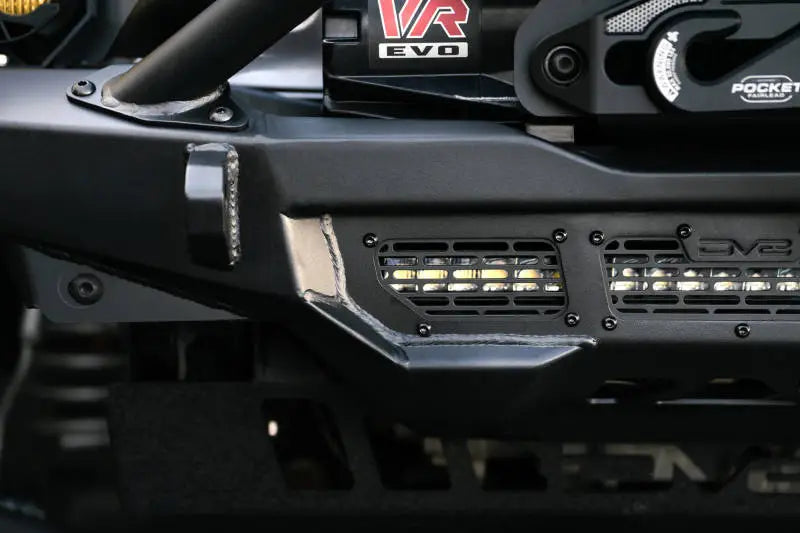 DV8 Offroad Spec Series Front Bumper for 2018-2023 Wrangler JL and Gladiator JT featuring high clearance design and winch mount with Warn 12s EVO displayed.