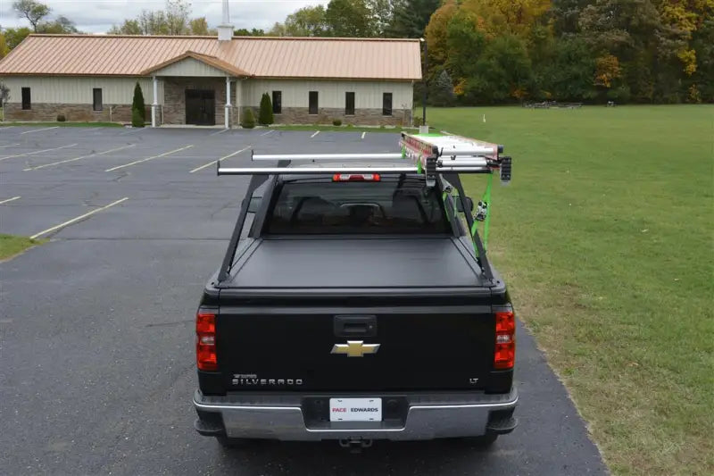 Black pickup truck with bed cover and rack featuring ELD0103 Pace Edwards El400 Series