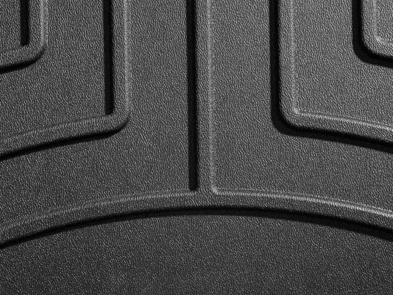 Textured black rubber floor liner molded fit with channels and WeatherTech logo