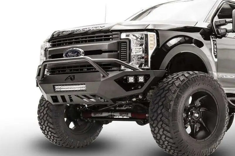 Fab Fours FS17-V4152-1 Vengeance Front Bumper on a 2017 Ford F250/F350, showcasing its heavy-duty construction, integrated 20" LED light bar, and winch-ready design.