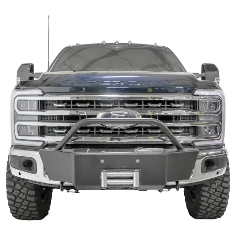 Front view of a truck equipped with the FS23-N5960-1 Fab Fours Winch Mount, showcasing its sturdy and secure mounting solution for enhanced off-road capabilities.