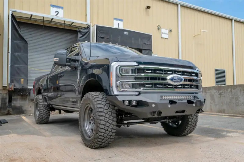 FS23-X5951-1 Fab Fours Matrix Front Bumper on a black Ford truck, showcasing rugged design, superior protection, and custom fit for easy installation.