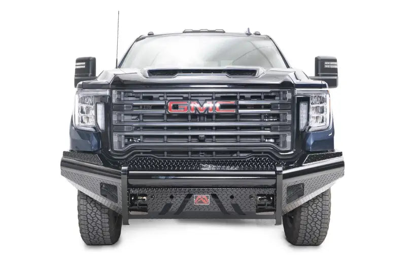 Front view of a GMC truck outfitted with the rugged GM20-S5061-1 Fab Fours Black Steel Front bumper, showcasing enhanced protection and a robust aesthetic.