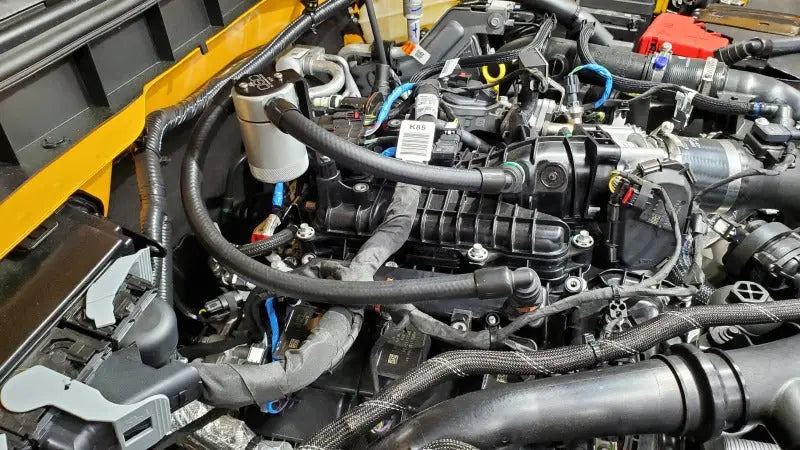Automobile engine compartment with J&L Ford Bronco 2021-2022 oil separator on passenger side