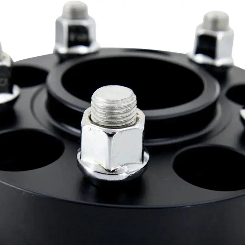 Black Mishimoto 5x114 15mm wheel spacers with lug nuts for better fitment