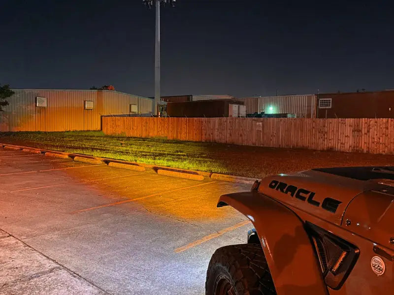 a jeep parked in a parking lot at night