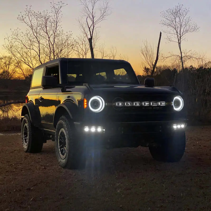 Black Ford Bronco with illuminated headlights in ORACLE Lighting fog light kit for 21-22 Bronco