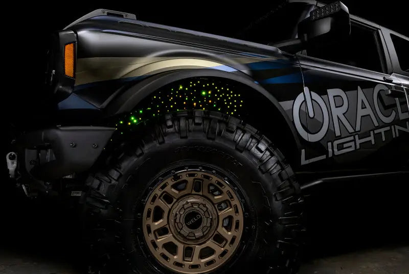 Illuminated off-road vehicle with Oracle Lighting Fiber Optic Wheel featuring RGBW lighting fiber optic system