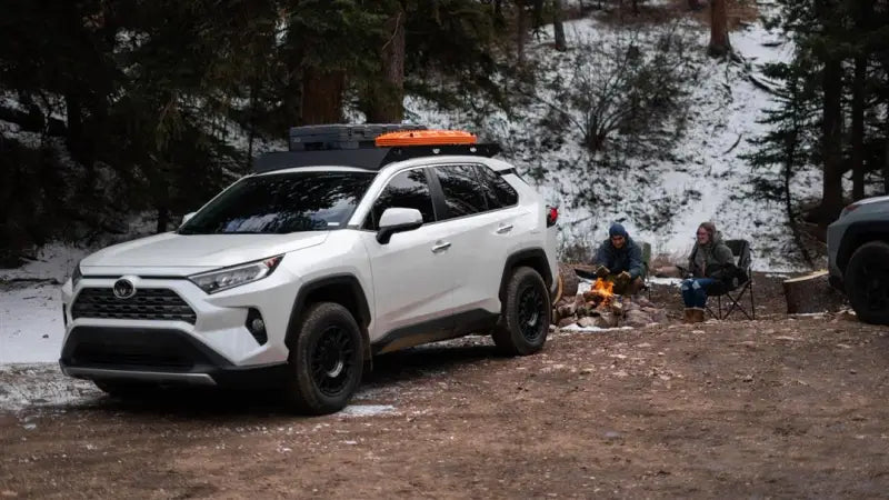 White SUV with black anodized roof rack and mounting hardware for a direct fit