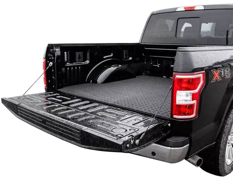 Open black pickup truck bed featuring the TG3-043-07 Legend Fleet Pickup Truck Bed Automat Bar Rubber, providing a non-slip surface for secure cargo transport, ideal for RV, Automotive, Powersports, off-road, marine, exterior, and interior truck accessories, Truck Bed Accessories, AVADA - Best Sellers, Must Haves