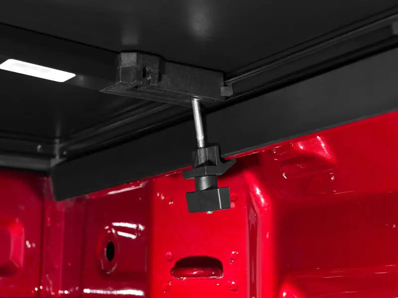 Black plastic adjustable truck bed tie-down bar with silver hardware for Toyota Tundra tonneau cover