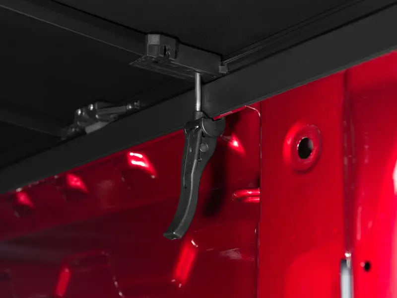 Black metal clamp with red accents for Toyota Tundra tonneau cover installation