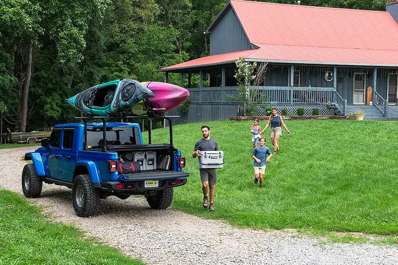 Blue pickup truck with kayaks on roof rack showcasing Truck Gear COOLER20 cooler gear cooler20