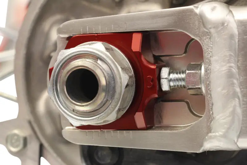 Motorcycle swingarm axle adjuster with 17-205 Axle Blocks Elite Hon Red for easy tuning
