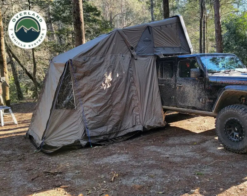 Mud-covered Jeep with attached VCL Bushveld Annex for overland adventures
