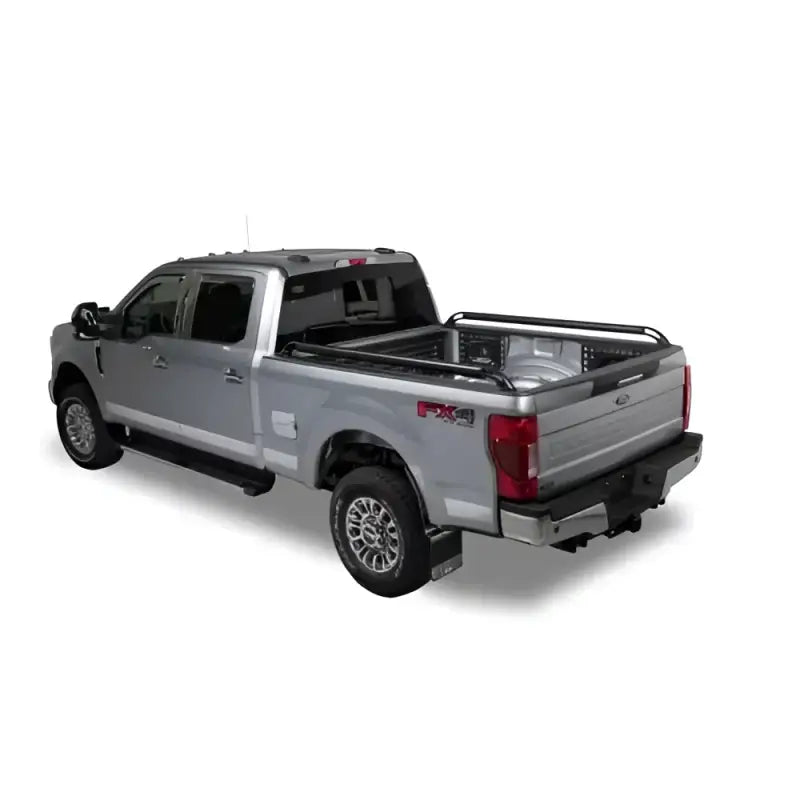 Silver pickup truck with bed rails.