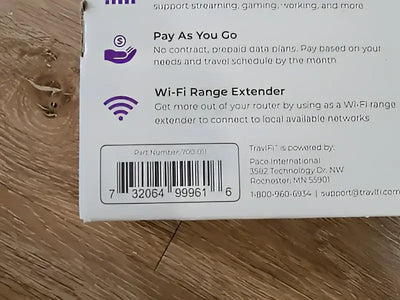 Close-up image of the 700-011 Pace Int'L Travlfi Journey Xtr Router packaging showing the barcode and part number on a wooden surface.