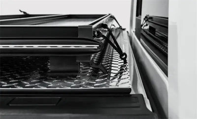 Black diamond plate Access LOMAX tri-fold truck bed cover with securing straps