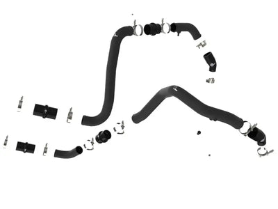 Black rubber automotive hoses with metal clamps on a hot charge pipe for Ford F-150 Raptor