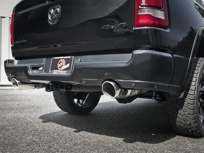Black truck rear with dual exhaust showing afe gemini xv 3in stainless steel tips