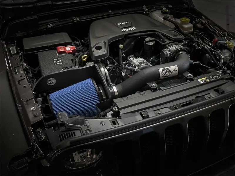 aFe Magnum FORCE Stage-2 XP Pro 5R Cold Air Intake System installed in a 2018+ Jeep Wrangler (JL) V6 3.6L engine bay, showcasing the oil-free 7-1/2" tall inverted top performance air filter and mandrel-bent wrinkle-black powder-coated aluminum intake tube.
