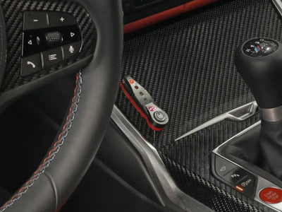 Interior of BMW M3 M4 with black leather steering wheel and afe scorcher bluetooth power module