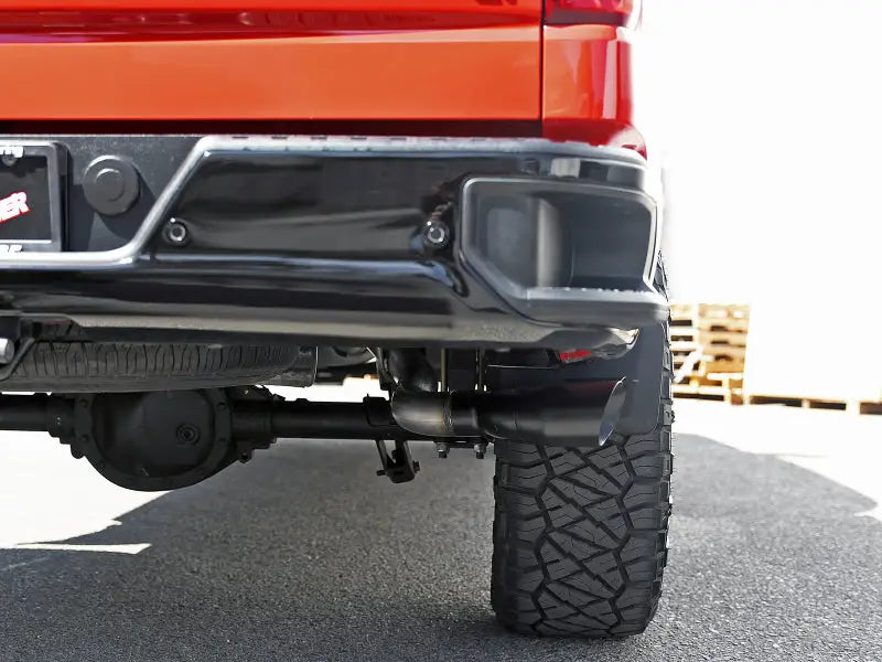 Truck’s rear end with afe vulcan series 3in 304ss exhaust and blk tip on Silverado