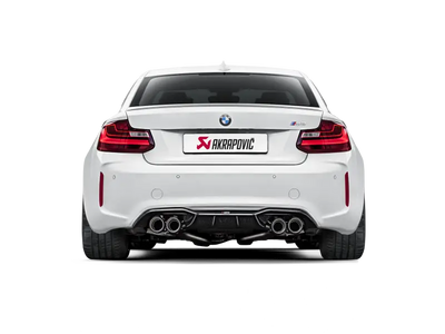 White BMW M2 with Akrapovic exhaust showcasing rear carbon fiber diffuser