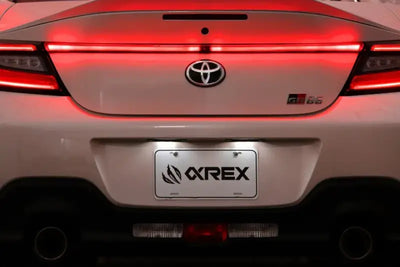 White Toyota GR86 rear view with AlphaRex LUXX LED Vivid Red trunk light