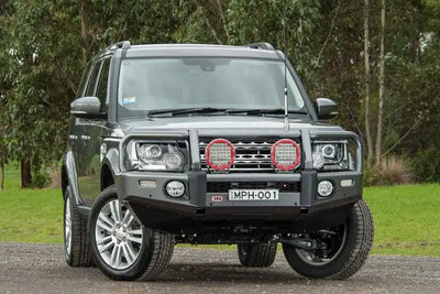 Gray Land Rover with bull bar featuring ARB Summit Combar and ARB Fog for Disco 4