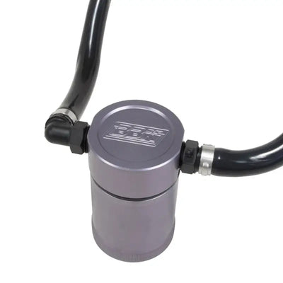Gray cylindrical oil separator with black hoses from BBK oil separator kit for Mustang GT