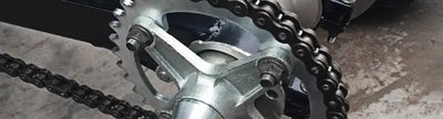 Silver sprocket with chain for Honda rear steel sprocket replacement on BikeMaster Honda Rear Steel Sprocket 520 39T Black