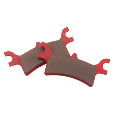 Three red and brown BikeMaster Polaris Sintered Brake Pads for high-performance brake pads