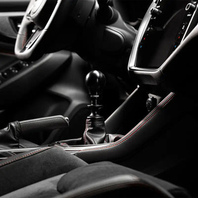 Stylish black car interior featuring COBB Subaru 6-Speed Weighted Knob and collars