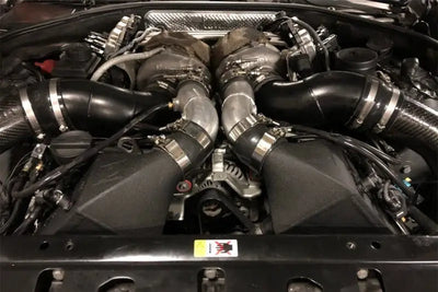 Car engine with twin turbochargers from CSF crinkle black twin charge-air-cooler set