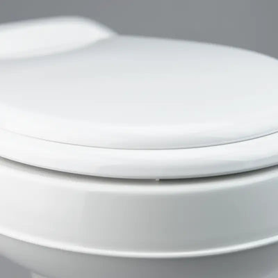 Dometic 300 Series RV Toilet with Easy Clean Design features a round seat and pedal flush control for convenience.