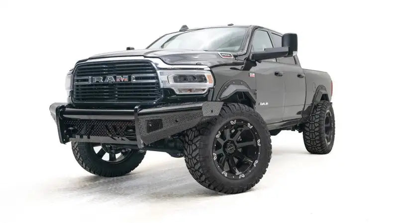 DR10-T2950-1 Fab Fours 10-14 Ddg Hd Rh Rear heavy-duty protection rear bumper installed on a black pickup truck, showcasing rugged design and durable construction for an aggressive look and enhanced vehicle defense.