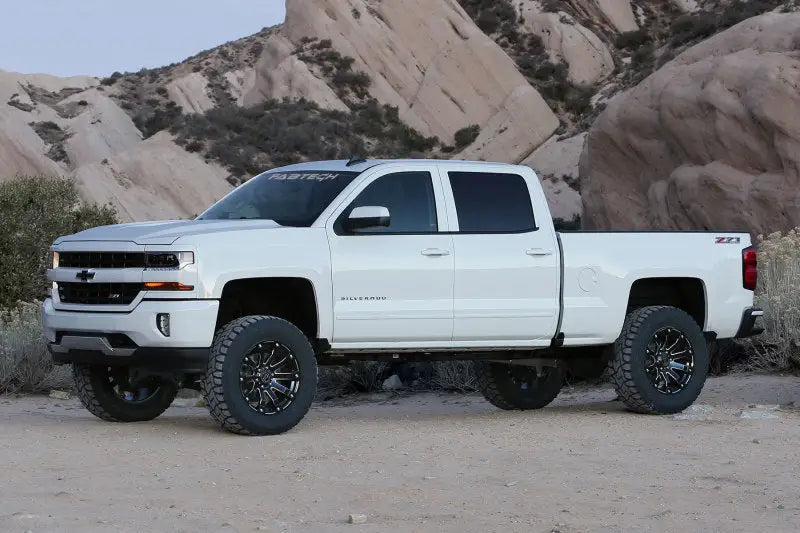 White pickup truck with large off-road tires, 6in basic lift, minor trimming required