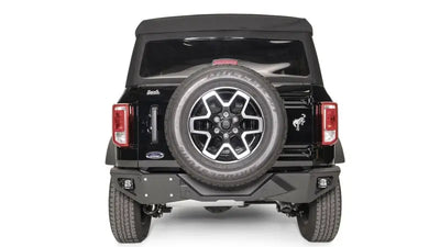 FB21-E5251-1 Fab Fours Vengeance Rear Bumper installed on a black Ford vehicle, showcasing rugged design and high-quality construction for superior rear-end protection and enhanced off-road performance.