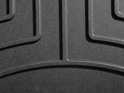 Textured black rubber floor liner molded fit with channels and reservoir for fluids